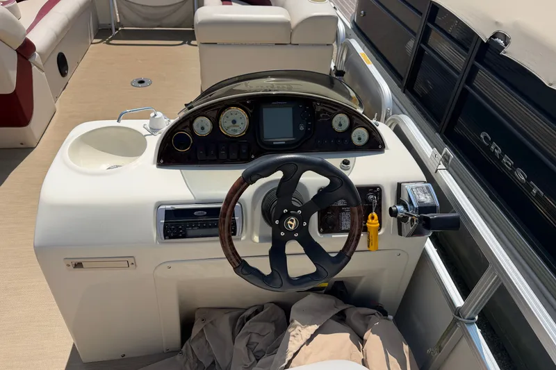 Slide: The Image of Steering console of a 2005 Tahoe Pontoon Sierra 20' boat with gauges and controls. - 8