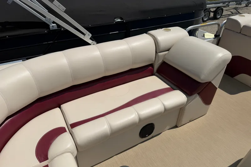 Slide: The Image of 2005 Tahoe Pontoon Sierra 20' boat interior with beige and maroon seating. - 14