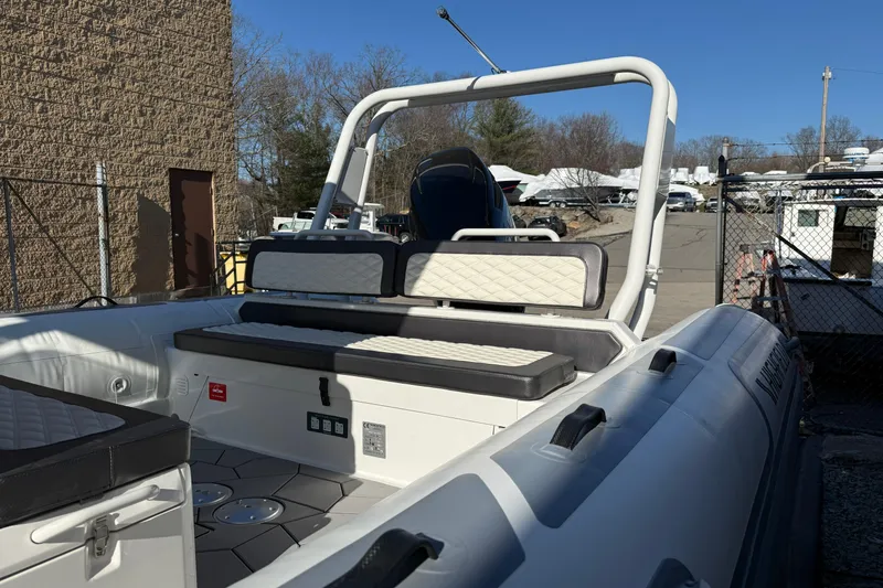 Slide: The Image of 2026 Highfield Sport 760 boat with cushioned seating, docked outdoors. - 7