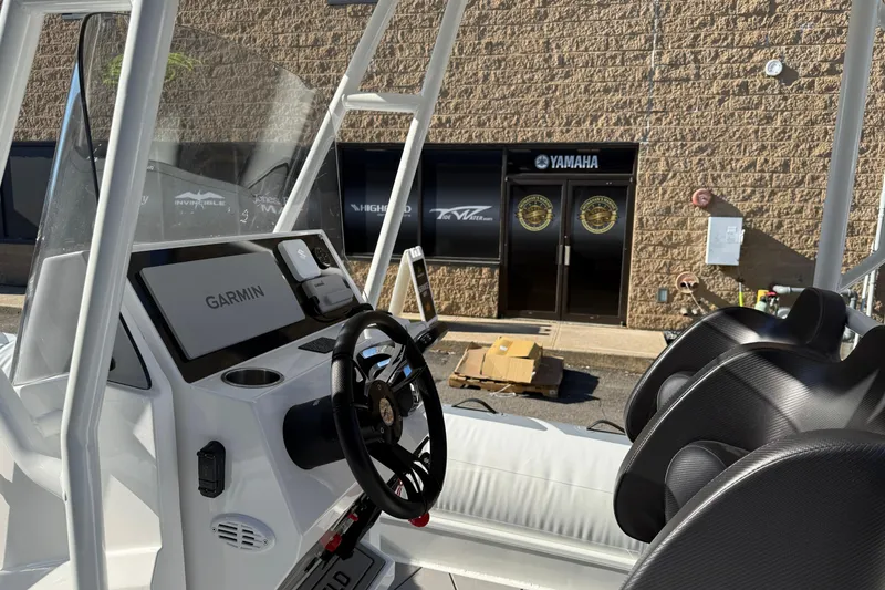 Slide: The Image of 2026 Highfield Sport 760 boat interior with Garmin navigation system, parked near Yamaha dealership. - 6