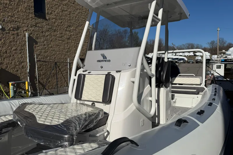 Slide: The Image of 2026 Highfield Sport 760 boat with sleek design and modern seating, docked outdoors. - 4