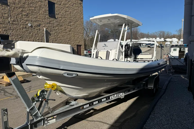 Slide: The Image of 2026 Highfield Sport 760 boat on trailer, parked outdoors under clear blue sky. - 3
