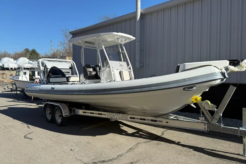 Slide: The Image of 2026 Highfield Sport 760 boat on trailer, parked outdoors near a building. - 2