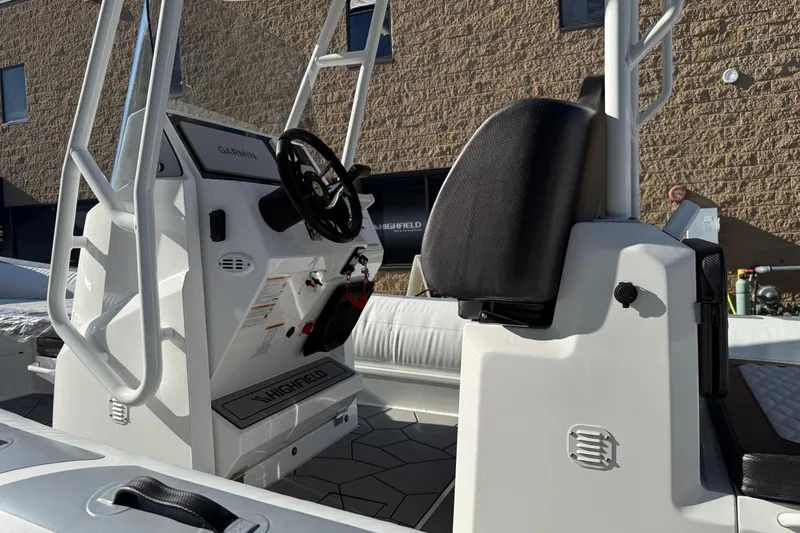 Slide: The Image of 2026 Highfield Sport 760 boat interior with steering console and seating. - 5