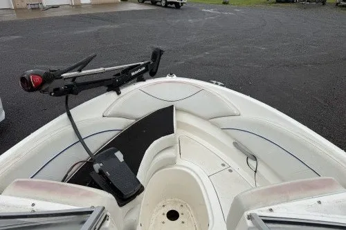 Slide: The Image of 2004 Bayliner 194 boat bow with trolling motor on a paved surface. - 9