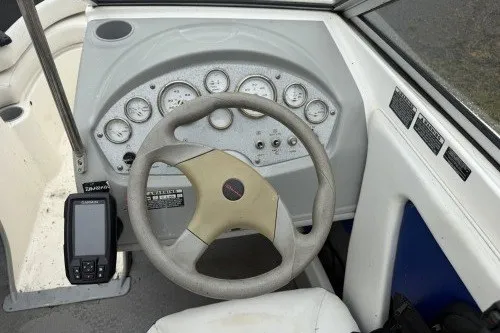 Slide: The Image of 2004 Bayliner 194 boat dashboard with steering wheel and gauges. - 7