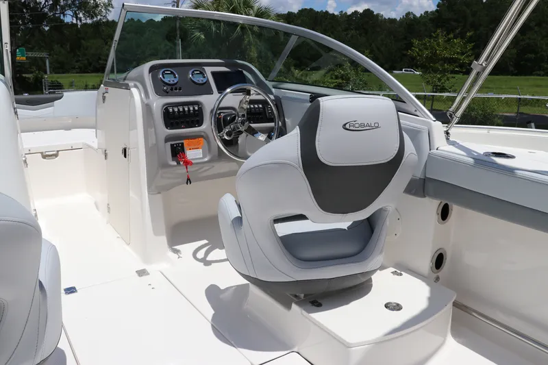 Slide: The Image of 2027 Robalo R207 Dual Console boat interior with steering wheel and dashboard controls. - 19