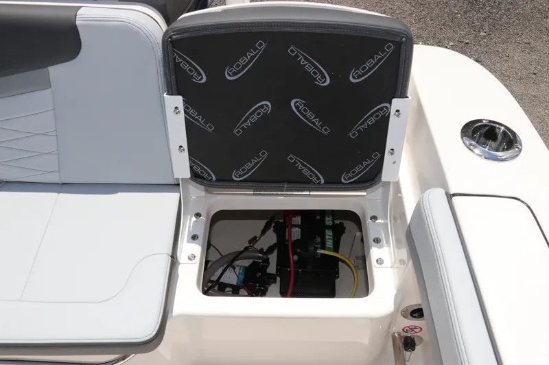 Slide: The Image of 2027 Robalo R207 Dual Console boat seat storage compartment with visible wiring. - 16