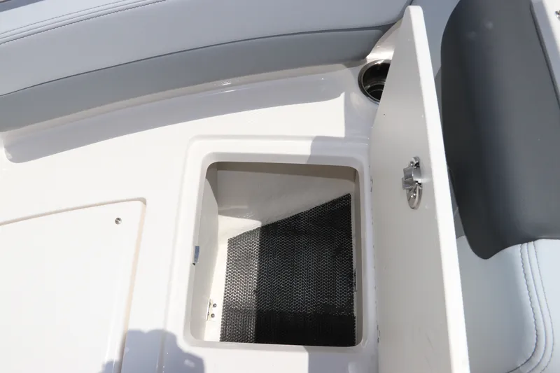 Slide: The Image of Open storage compartment on 2027 Robalo R207 Dual Console boat. - 37