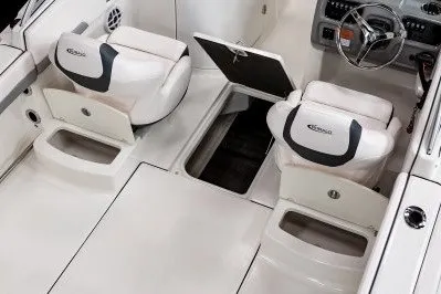 Slide: The Image of 2027 Robalo R207 Dual Console boat interior with white seating and storage compartments. - 5