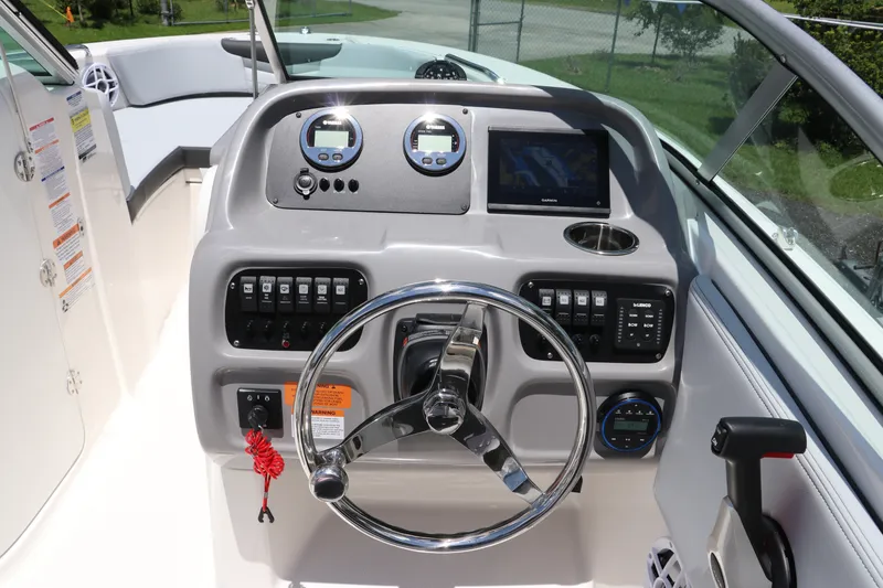Slide: The Image of 2027 Robalo R207 Dual Console boat dashboard with steering wheel and control panel. - 25