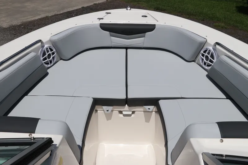 Slide: The Image of 2027 Robalo R207 Dual Console boat interior with cushioned seating and built-in speakers. - 33