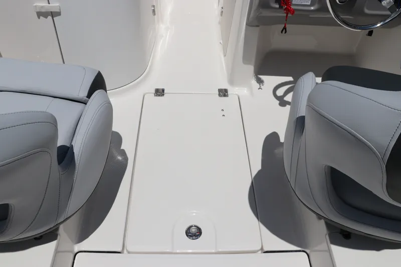 Slide: The Image of 2027 Robalo R207 Dual Console boat interior with gray seating and steering wheel. - 20