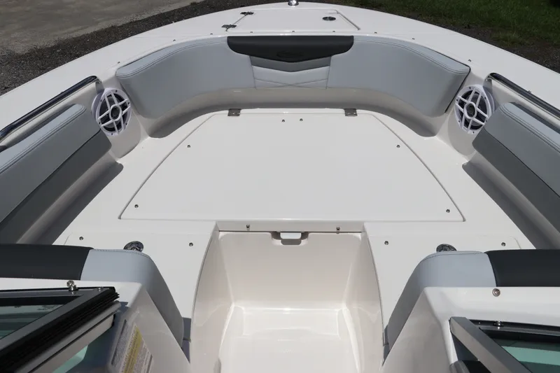 Slide: The Image of 2027 Robalo R207 Dual Console boat interior with cushioned seating and speakers. - 34