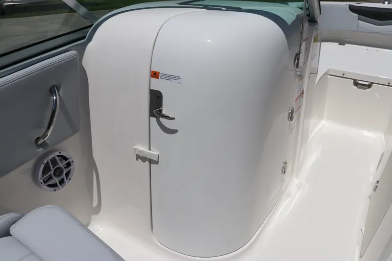 Slide: The Image of 2027 Robalo R207 Dual Console interior with white seating and storage compartment. - 22