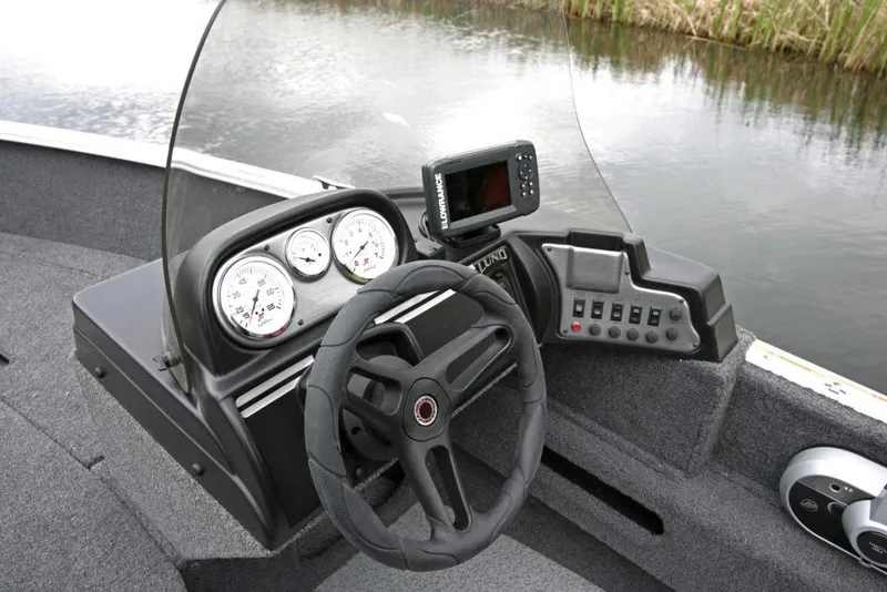 Slide: The Image of Manufacturer Provided Image: Dashboard of a 2020 Lund 1675 Adventure SS boat with steering wheel and gauges. - 20
