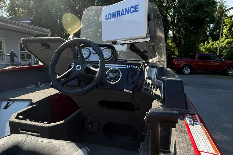 Slide: The Image of 2020 Lund 1675 Adventure SS boat dashboard with Lowrance electronics and steering wheel. - 6
