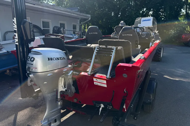 Slide: The Image of 2020 Lund 1675 Adventure SS boat with Honda 20 outboard motor, parked outdoors. - 1