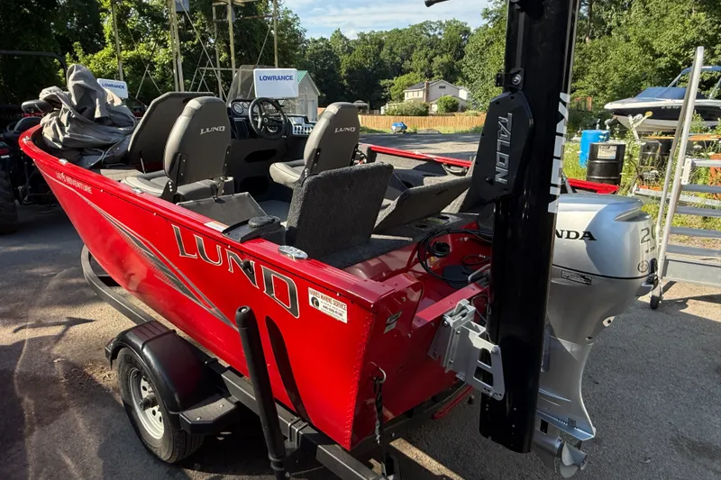 Slide: The Image of 2020 Lund 1675 Adventure SS boat with Honda outboard motor, parked on a trailer. - 4
