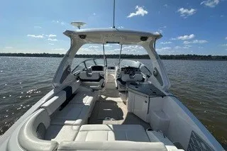 Slide: The Image of 2013 Chaparral 327 SSX boat interior on a sunny day, open water view. - 13