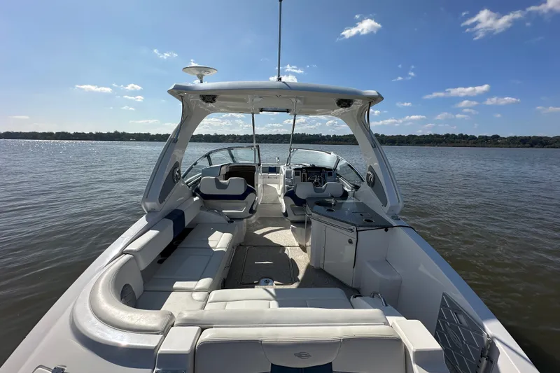 Slide: The Image of 2013 Chaparral 327 SSX boat interior on a sunny day, with open water view. - 33