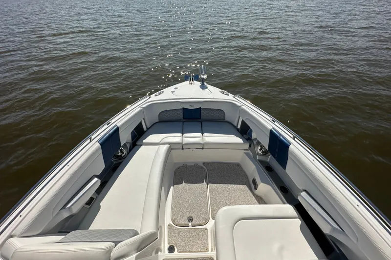 Slide: The Image of 2013 Chaparral 327 SSX boat interior with white seating on calm water. - 36