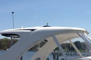 Slide: The Image of 2013 Chaparral 327 SSX boat with sleek design, docked by the water. - 15