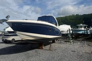 Slide: The Image of 2013 Chaparral 327 SSX boat on dry dock, surrounded by other vessels. - 4