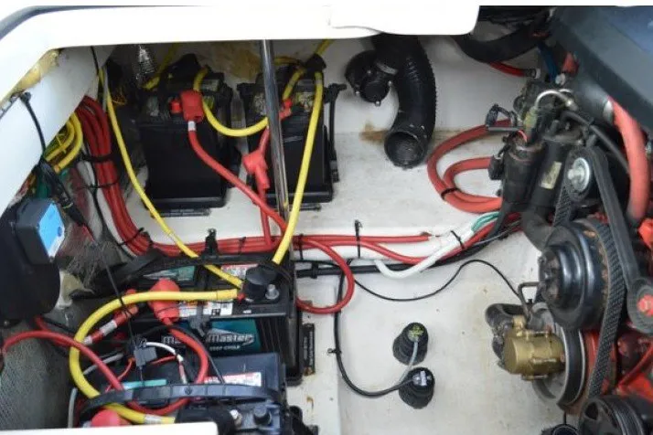 Slide: The Image of Engine compartment of 2013 Chaparral 327 SSX with visible wiring and battery setup. - 52