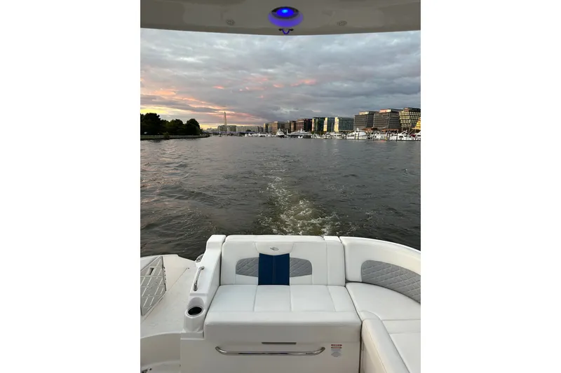 Slide: The Image of 2013 Chaparral 327 SSX cruising on a river at sunset with cityscape views. - 18