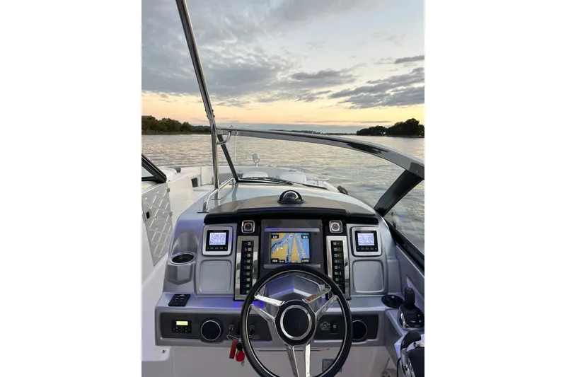 Slide: The Image of Cockpit view of 2013 Chaparral 327 SSX boat at sunset on a calm lake. - 24