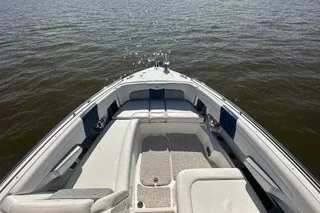 Slide: The Image of 2013 Chaparral 327 SSX boat with spacious seating on calm water. - 11