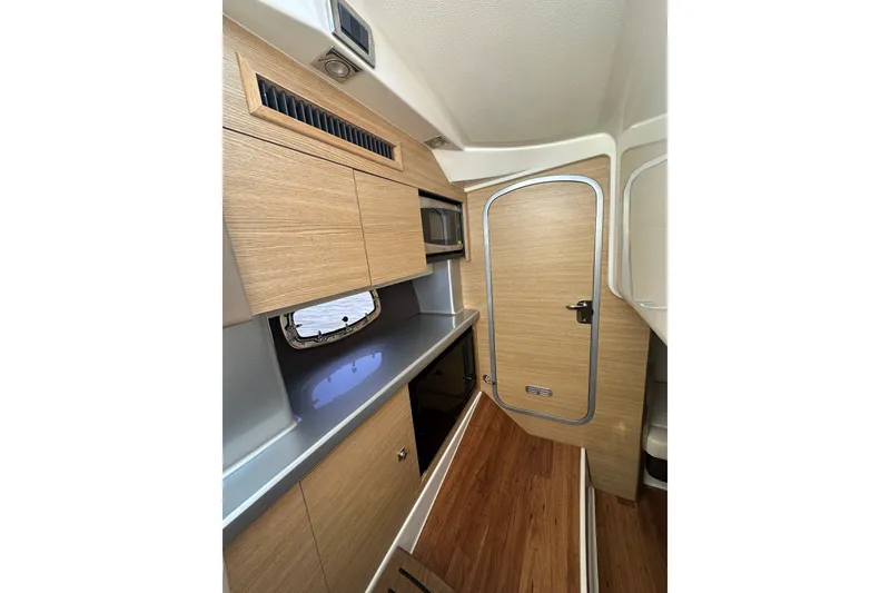 Slide: The Image of Interior of 2013 Chaparral 327 SSX boat with wood cabinetry and sleek design. - 40