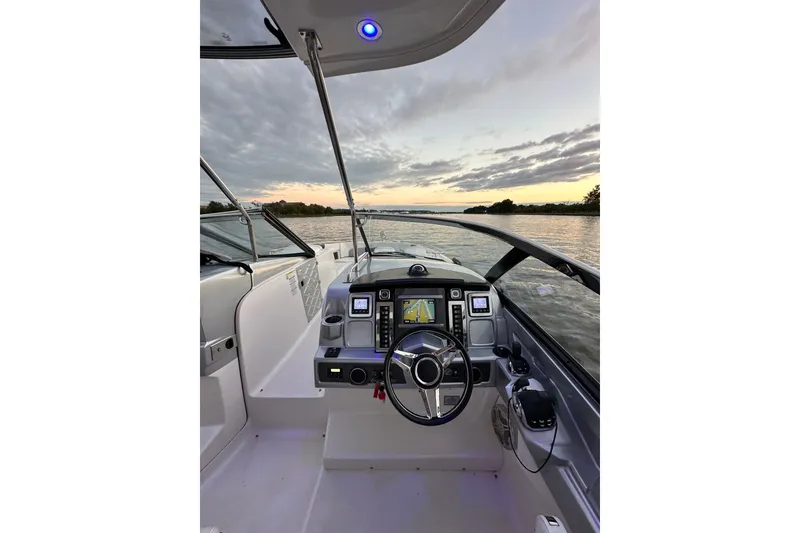 Slide: The Image of Cockpit view of 2013 Chaparral 327 SSX boat at sunset on the water. - 23