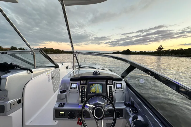 Slide: The Image of Cockpit view of 2013 Chaparral 327 SSX boat at sunset on a calm river. - 25