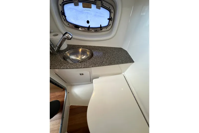 Slide: The Image of Interior of 2013 Chaparral 327 SSX boat featuring a compact sink and countertop. - 45