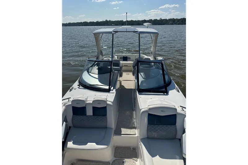 Slide: The Image of 2013 Chaparral 327 SSX boat on calm water, featuring sleek design and spacious seating. - 34