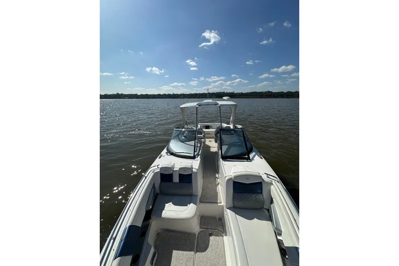Slide: The Image of 2013 Chaparral 327 SSX boat on calm water under a clear blue sky. - 35