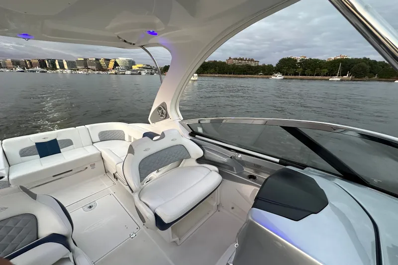 Slide: The Image of 2013 Chaparral 327 SSX boat interior with waterfront view and modern seating. - 20