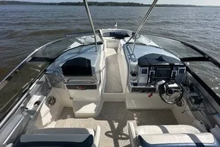 Slide: The Image of 2013 Chaparral 327 SSX boat interior with steering wheel and dashboard on open water. - 14