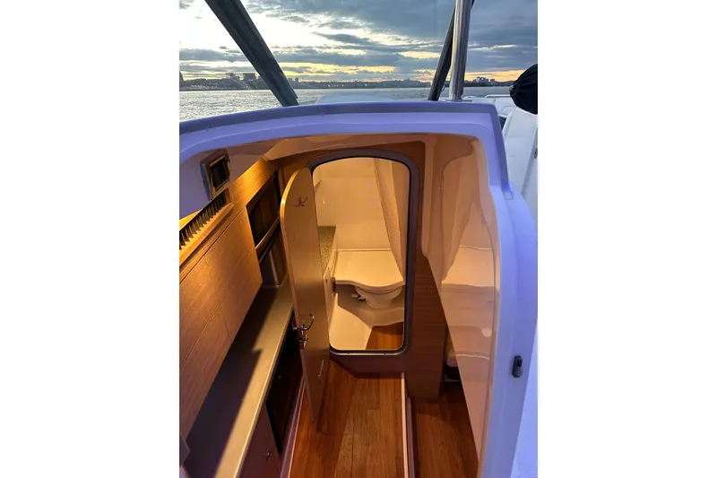 Slide: The Image of Interior view of 2013 Chaparral 327 SSX boat cabin at sunset. - 43