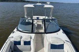 Slide: The Image of 2013 Chaparral 327 SSX boat on open water, featuring sleek design and spacious seating. - 7
