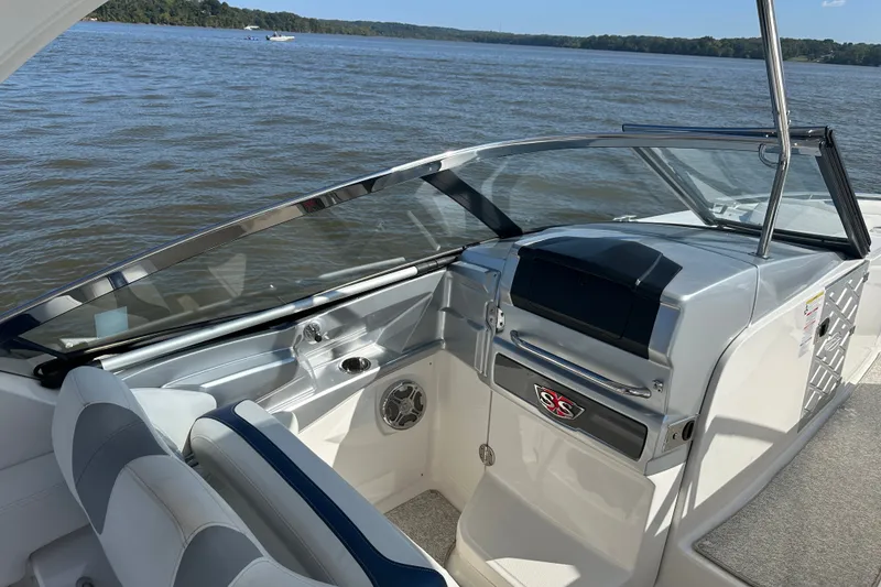 Slide: The Image of 2013 Chaparral 327 SSX boat interior with sleek dashboard and comfortable seating. - 38
