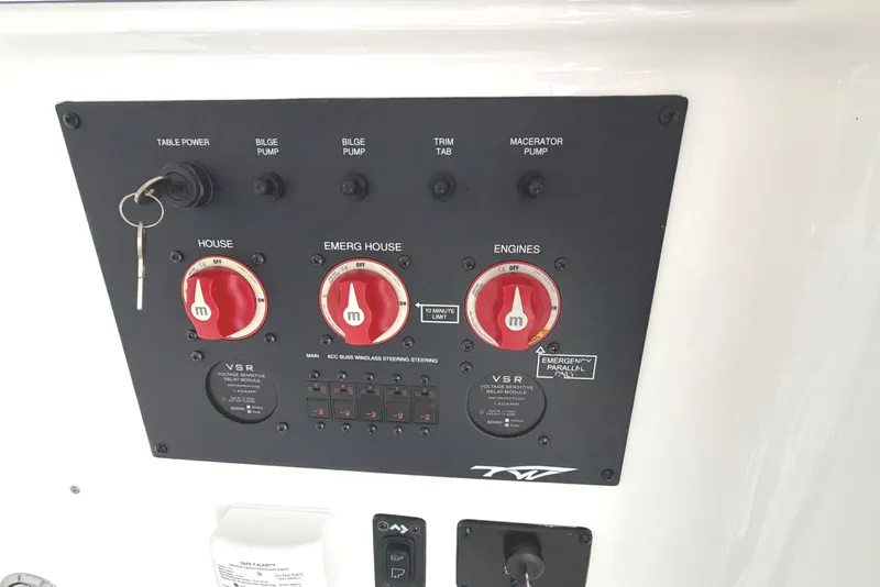 Slide: The Image of Control panel of 2026 Tidewater 320 CC Adventure boat with switches and key. - 50