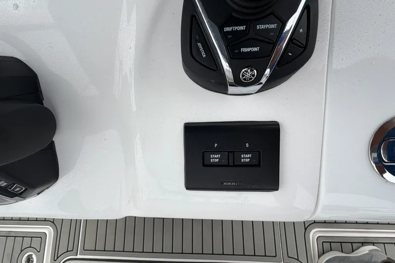Slide: The Image of 2026 Tidewater 320 CC Adventure boat controls with joystick and start-stop buttons. - 44