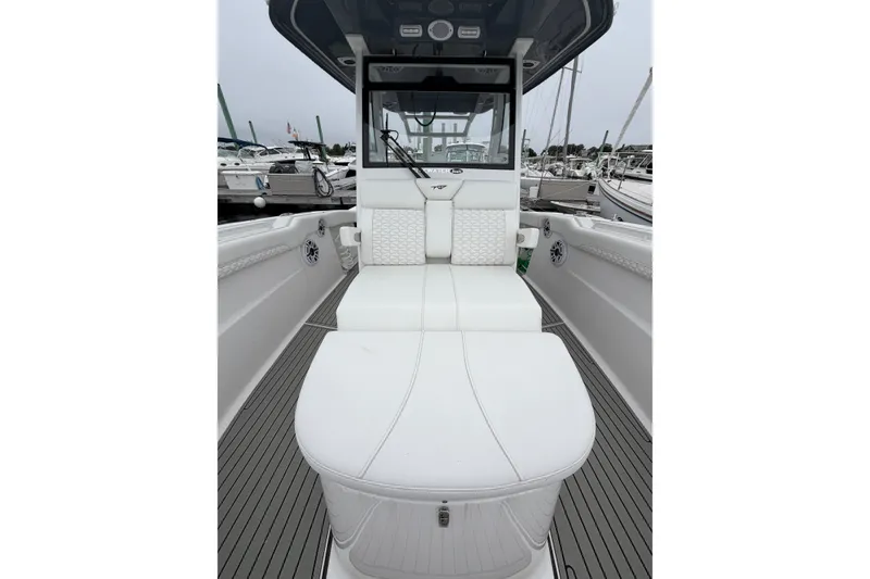 Slide: The Image of 2026 Tidewater 320 CC Adventure boat interior with white seating and sleek design. - 68