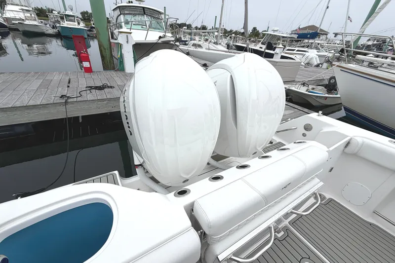 Slide: The Image of 2026 Tidewater 320 CC Adventure boat with dual engines docked at marina. - 48
