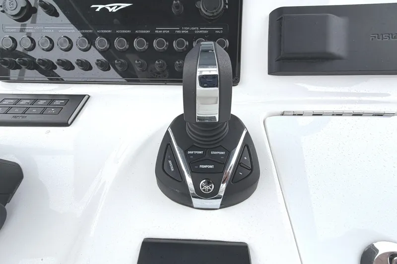 Slide: The Image of Control panel of 2026 Tidewater 320 CC Adventure boat with joystick and buttons. - 19