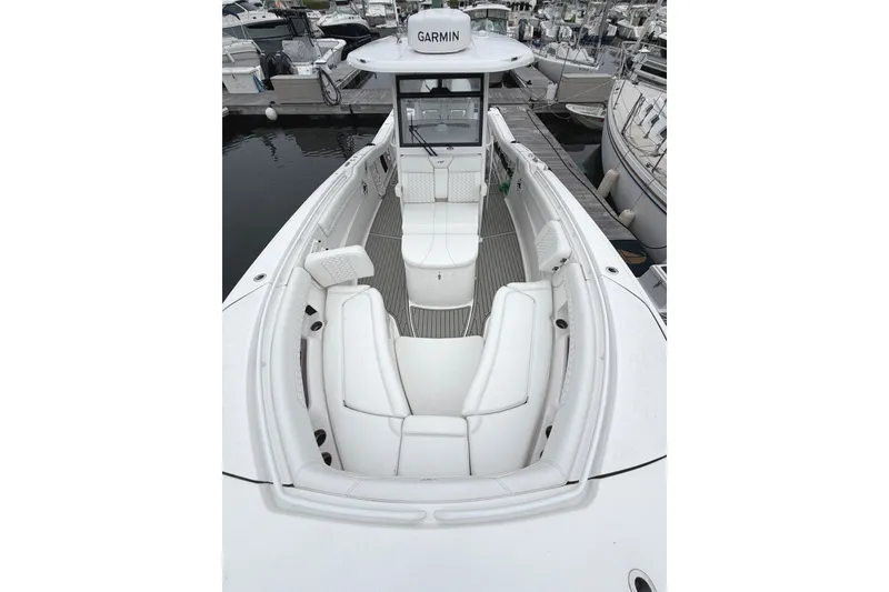Slide: The Image of 2026 Tidewater 320 CC Adventure boat with sleek white seating and Garmin navigation. - 66