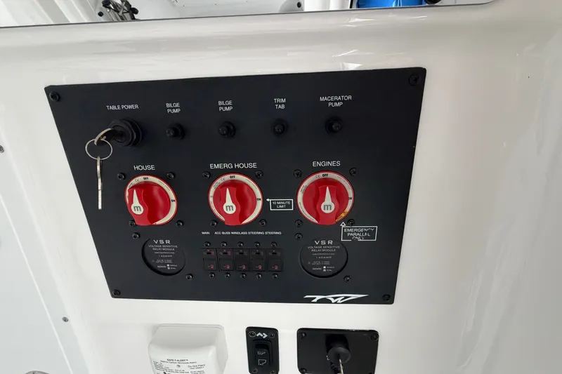 Slide: The Image of Control panel of 2026 Tidewater 320 CC Adventure boat with switches and key. - 29